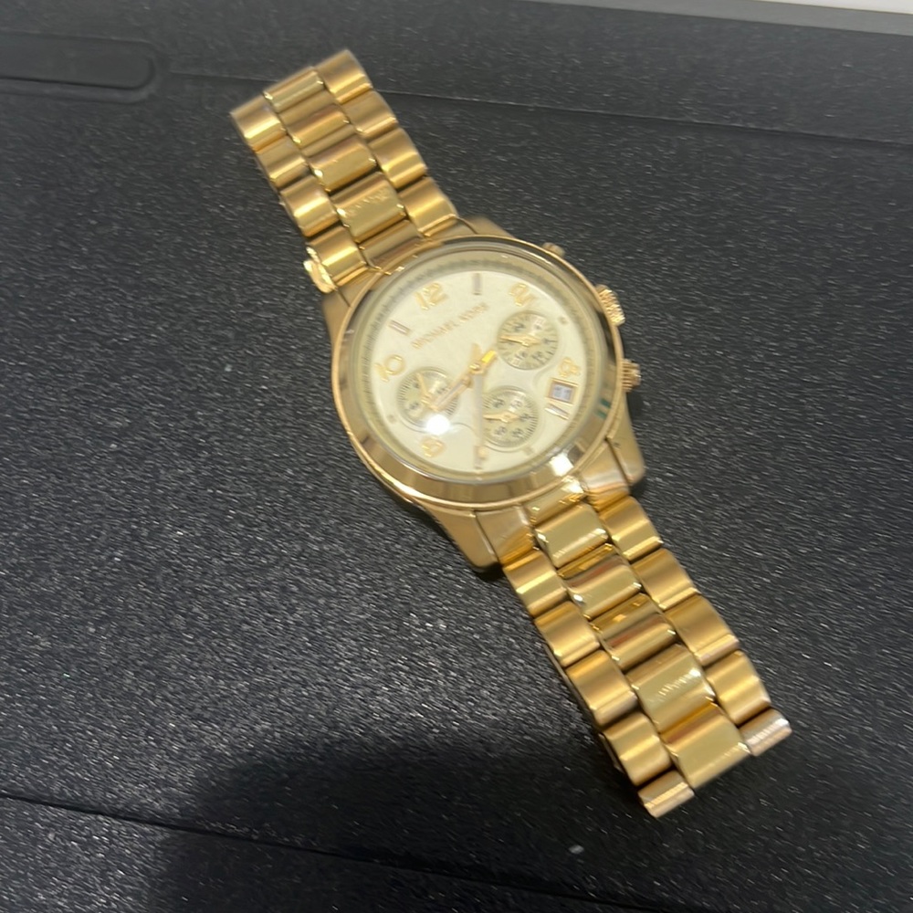 Michael Kors gold oversized watch will fit from small to medium wrist.